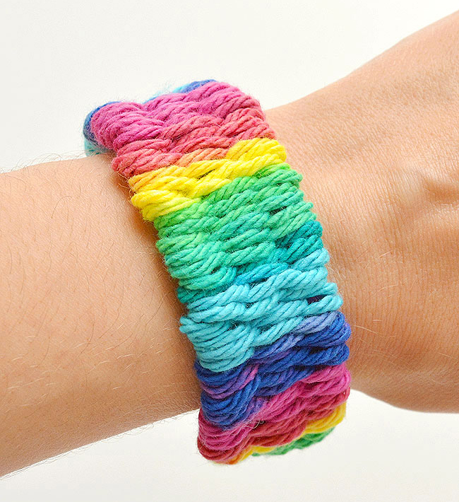 photo of wrist with rainbow weaved bracelet