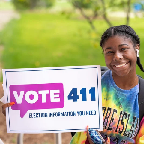 young person holding Vote 411 sign