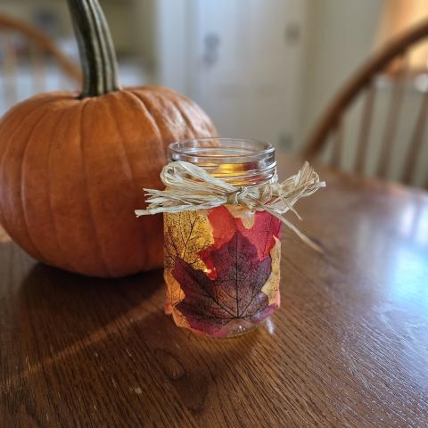 pumpkin and candle holder on a tabletop