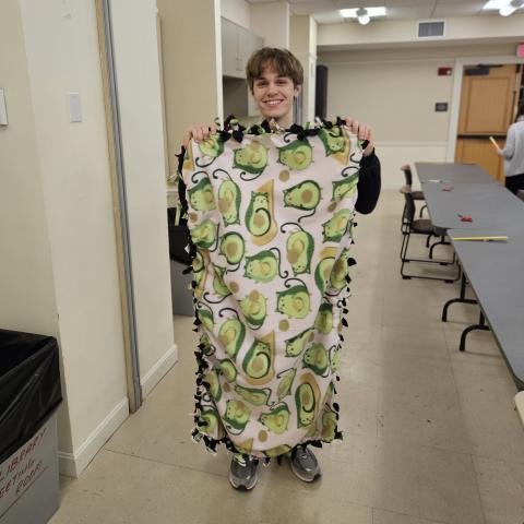 young person holding fleece blanket