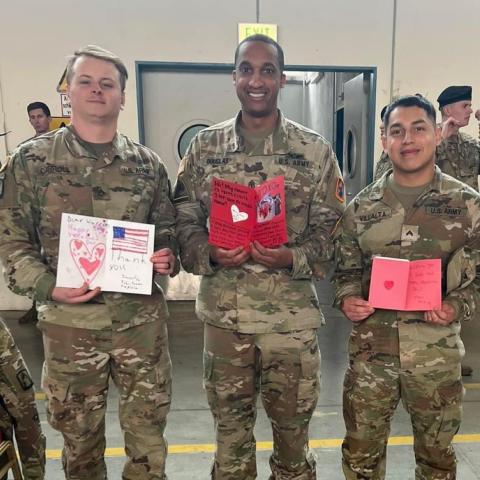 soldiers holding handmade cards