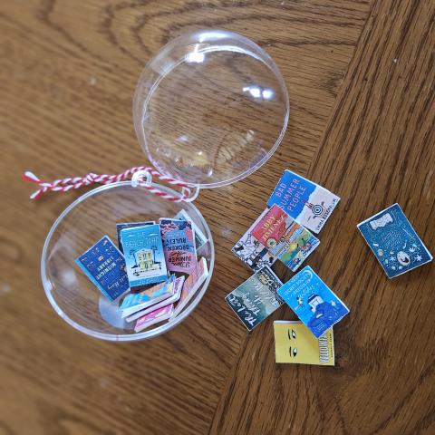 Clear plastic ornament filled with miniature books