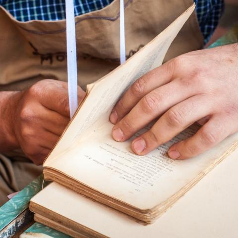 person repairing an old book