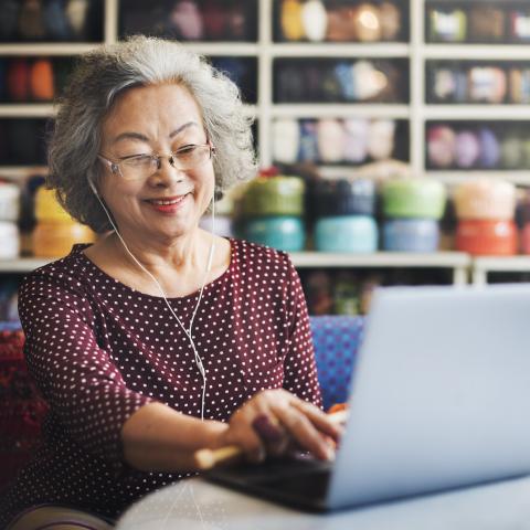 Woman smiling at computer screen