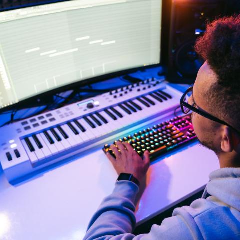 person on a computer making music