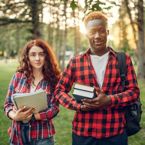 Two students holding books