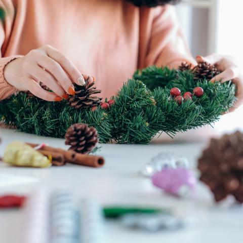 person decorating wreath