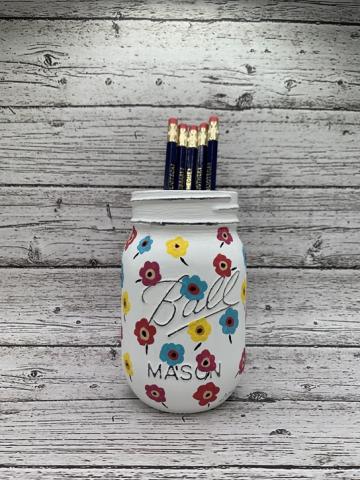 mason jar painted with colorful flowers