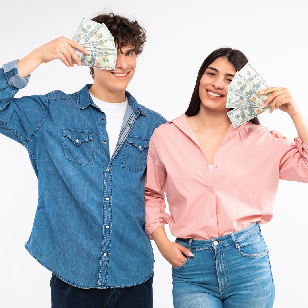 Photo - 2 teens holding dollar bills