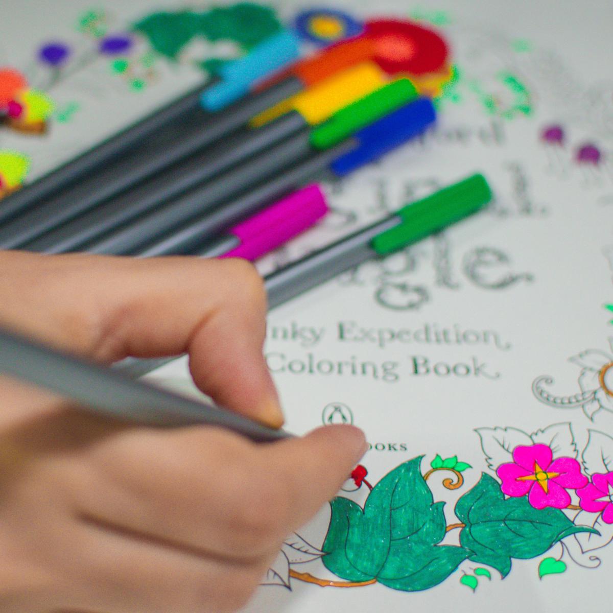 person coloring with markers