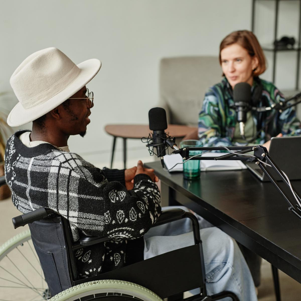 two people sitting and talking in front of microphones